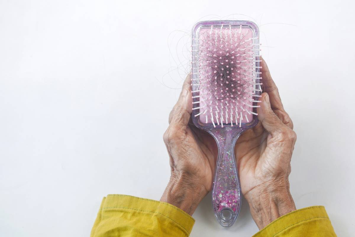 Close-up of dry brushing for lymphatic technique showing upward strokes toward heart